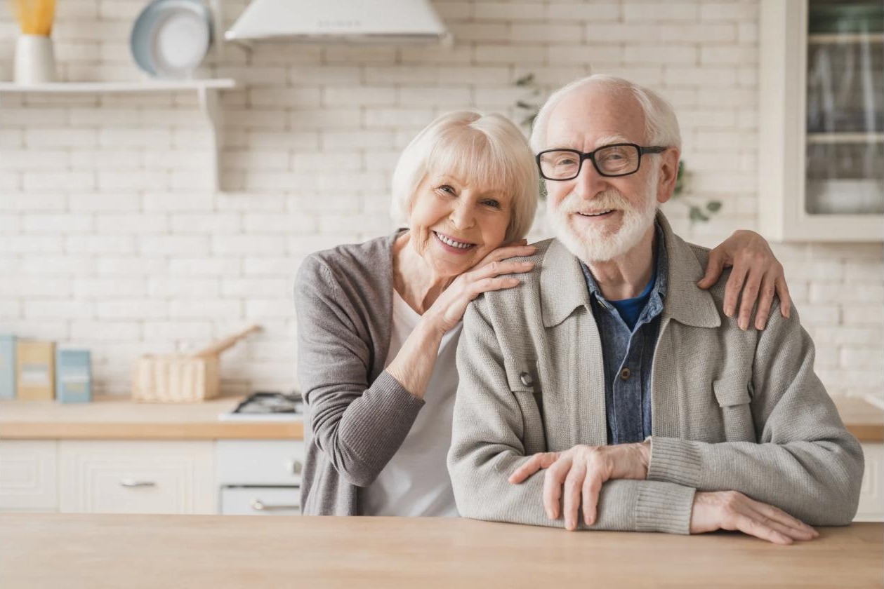 A smiling senior couple in their kitchen
